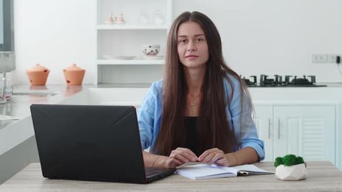 Young Beautiful Brunette Works on a Laptop Computer in Cool Creative Agency in a Loft Ofice
