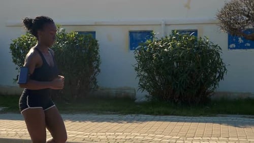 Woman Jogging on Sidewalk in the Daytime