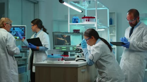 Scientists Working Diligently Inside of a Bright Lab