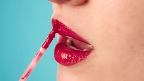Woman Applying Red Lipstick Close Up on Lips