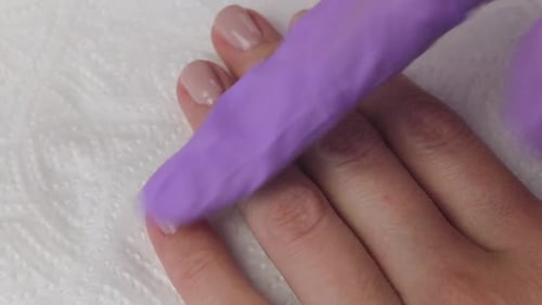 Youg Woman Greases Fingers with Oil After Manicure. Nails Manicure