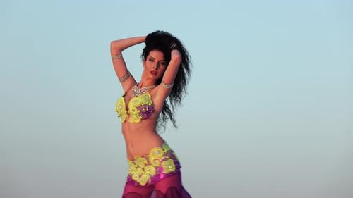 Woman with Curly Hair Performs Belly Dance