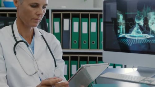 Doctor Using Tablet Computer in Medical Office