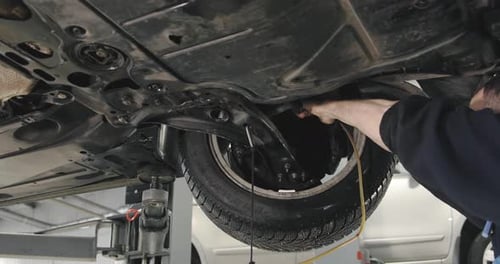 Mechanic Draining Old Brake Fluid From A System During The Service. Close Up