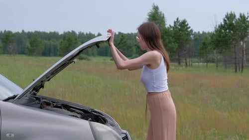Woman Opens Car Hood to Check Engine