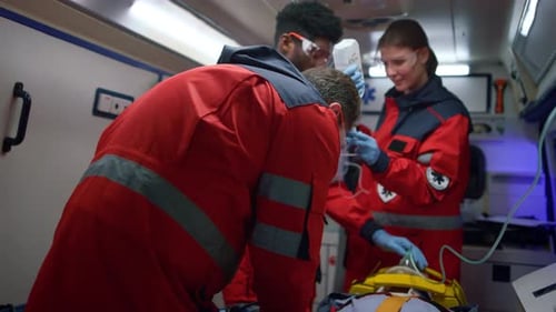 Paramedics Providing Urgent Medical Assistance in Ambulance