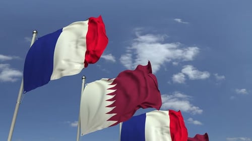Waving Flags of Qatar and France Under Blue Sky
