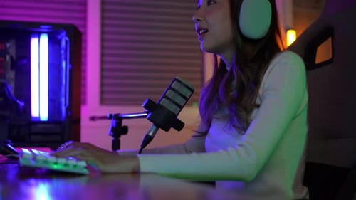 Gamer e E-Sport online de mulher asiática jogando vídeo de computador online com efeito de iluminação