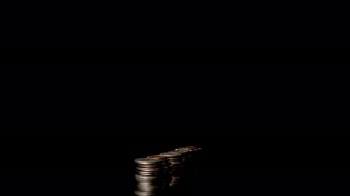 Growing Coin Stacks on Dark Reflective Surface