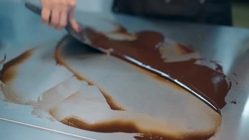 Chocolate Tempering Technique Using Spatula on Table