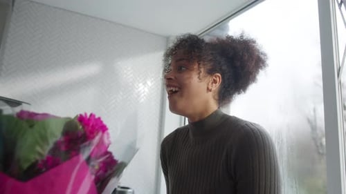 Woman Receives Flowers and Hugs From Man