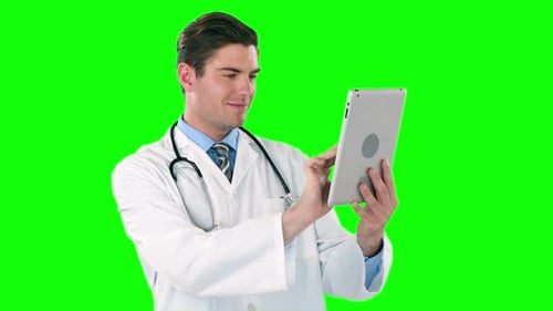 Doctor Using Tablet Computer Against Green Screen