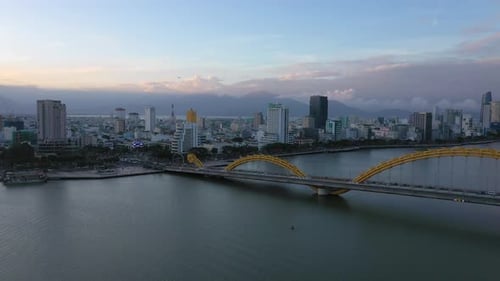 Aerial dragon bridge and skyline at sunset, DaNang city, Vietnam.
