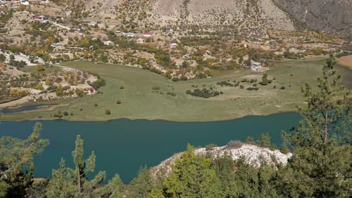 Beautiful Green Mountain Valley with Blue River and Settlement Top View