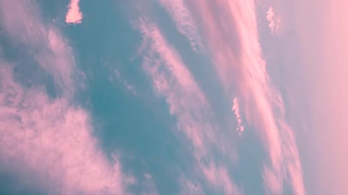 Pink Clouds Drifting Slowly in Turquoise Sky