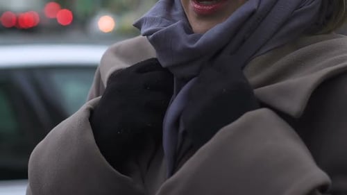 Woman Adjusting Gloves on City Street, Close Up