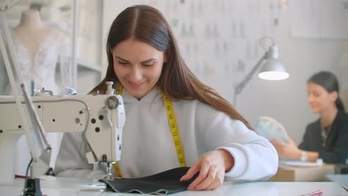 Woman Using Sewing Machine in Sunny Workshop