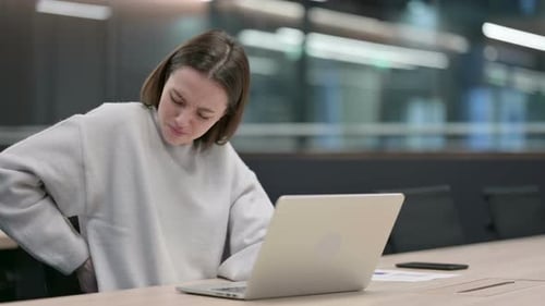 Woman Experiencing Back Pain While Using Laptop