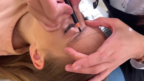 Woman Receives Eyebrow Cosmetic Procedure in Salon