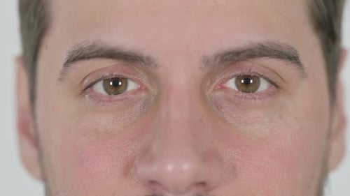 Close Up of Blinking Eyes of Man Looking at the Camera