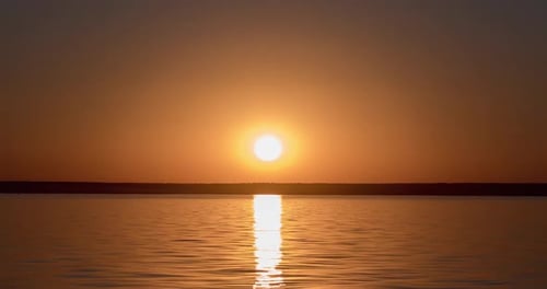 Golden Sunset Over Tranquil Lake Waters