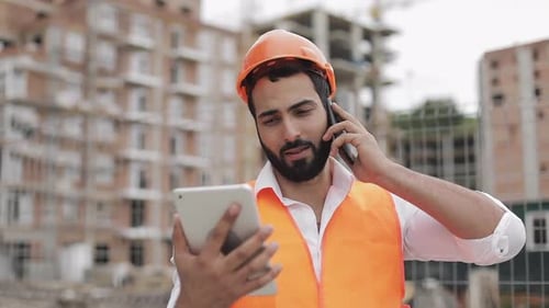 Inspector Building Supervisor Engineer Talking on Smartphone and Working on Tablet
