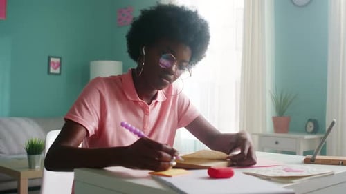 Young Adult Studying at Table Indoors