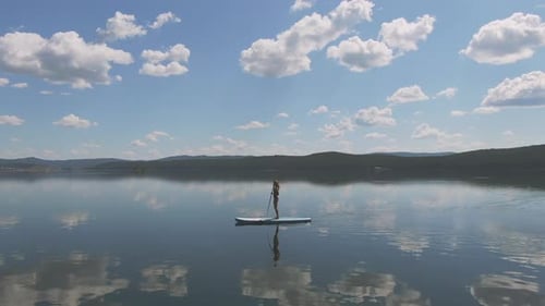 Standup Sup Surfing in Reflecting Water