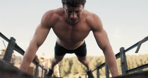 Muscular Man Doing Push-ups Outdoors