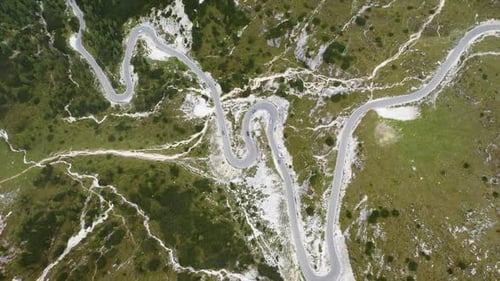 Cars passing through curve in mountainous road. Mountain serpentine road