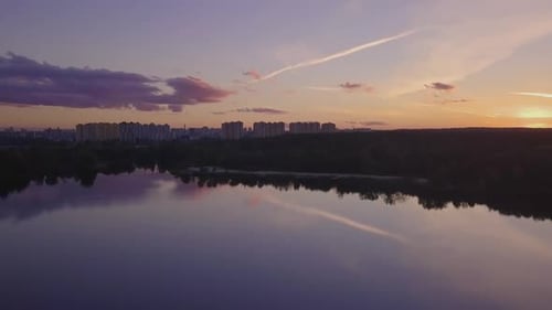 Flight Over the Lake During Sunset Overlooking the City with Beautiful Clouds Ukraine Kiev
