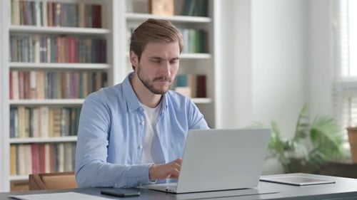 Man Giving Thumbs Up While Using Laptop