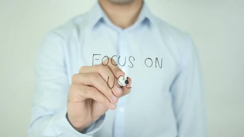 Hand Writes Focus On User on Clear Surface