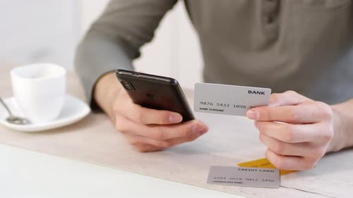 Unrecognizable Man Buying Online with Smartphone and Credit Card