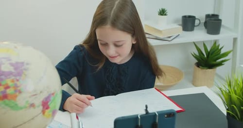 Young Girl Studies at Home with Virtual Learning
