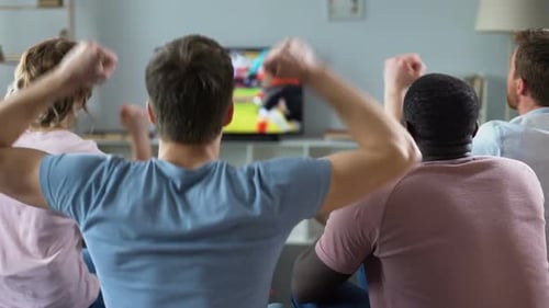 Friends Watch Sports Game Together in Living Room
