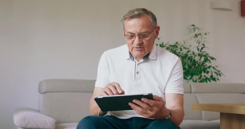 Mature Adult Using a Tablet at Home
