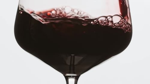 Sommelier gießt einen ausgezeichneten Rotwein in ein Glas. Roséwein in Glas gießen.