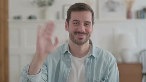 Man Waving Hand in Friendly Greeting