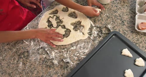 Child and Adult Baking Holiday Cookies Together