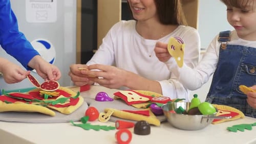 Family fun making toy pizzas