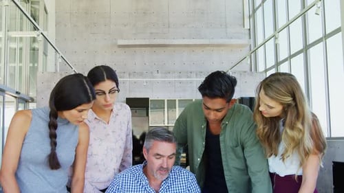 Diverse Team Collaborating with Manager in Modern Office
