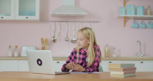 Focused Girl Studying at Home with Laptop