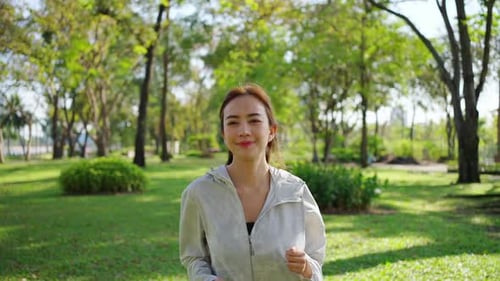 4K Asian woman jogging exercise at public park in the morning