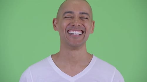 Adult Bald Man Laughing in Front of Green Screen
