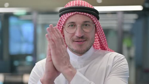 Smiling Man with Headscarf Clapping Hands