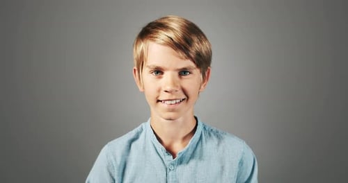 Blonde Haired Boy Smiling in Studio Portrait