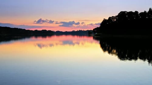 Sunset in the sun above the lake in summer