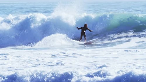 Surfers surfing in sea