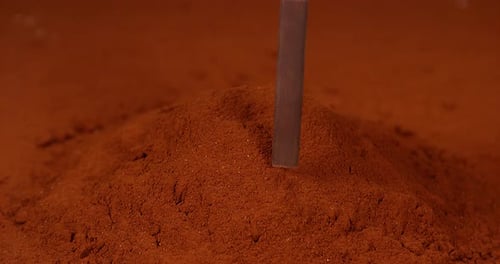 Chocolate Pieces Inserted into Cocoa Powder